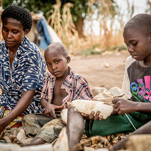 Grace Ninseka one of the beneficiaries of the program peeling cassava